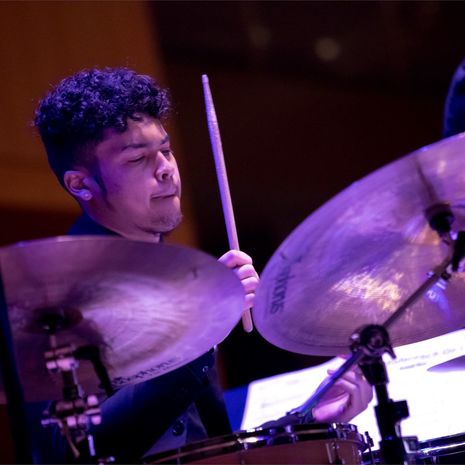 Student playing snares in a jazz band