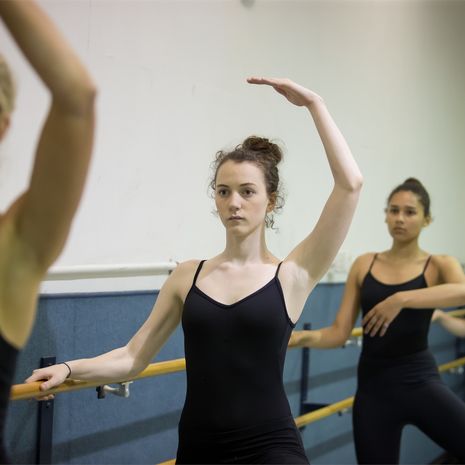 Student ballet dancers run through positions in a Boyer performance room at Temple