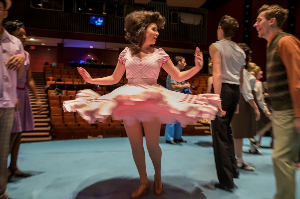 Actor twirling her dress on stage