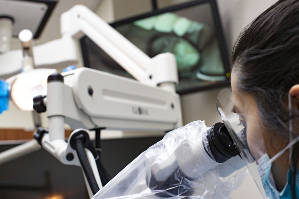 An Endodontics graduate certificate student working in a clinic. 